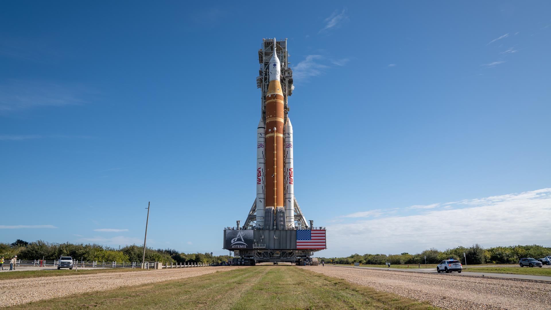 This image shows NASA’s SLS (Space Launch System) and Orion spacecraft rolling out of the Vehicle Assembly Building at NASA’s Kennedy Space Center. NASA's massive Crawler-Transporter, upgraded for the Artemis program, carries the powerful SLS rocket and Orion spacecraft on the Mobile Launcher from the Vehicle Assembly Building to Launch Pad 39B at Kennedy Space Center in preparation for the Artemis II mission.